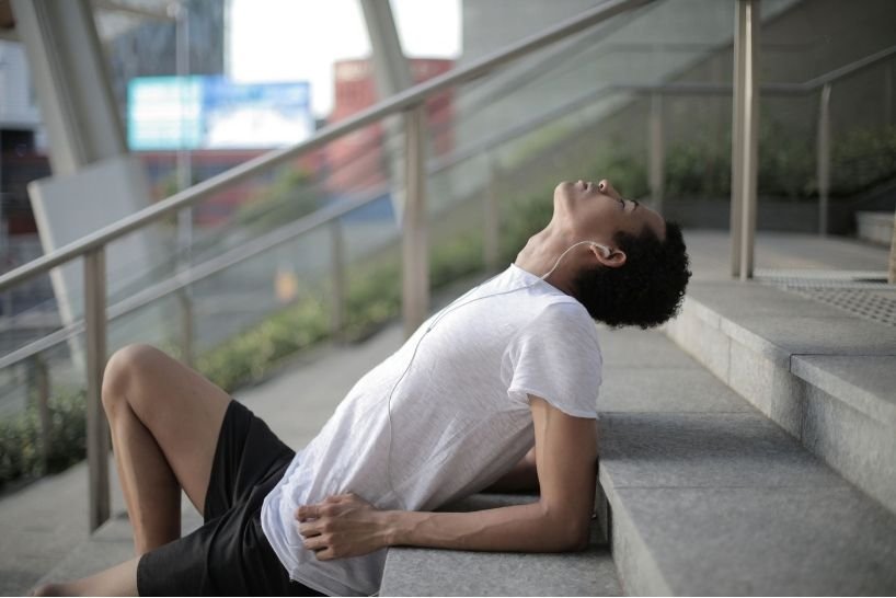 Athletic man relaxing and breathing deeply outdoors to lower cortisol and reduce stress