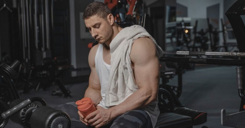 Athlete holding a shaker bottle to manage creatine monohydrate water retention