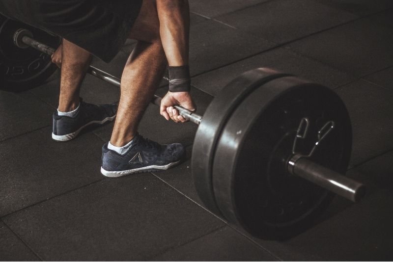 Heavy barbell deadlift demonstrating progressive overload for muscle hypertrophy